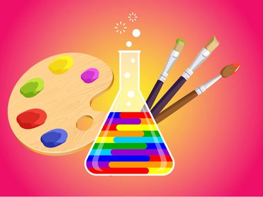 paint brushes behind a beaker